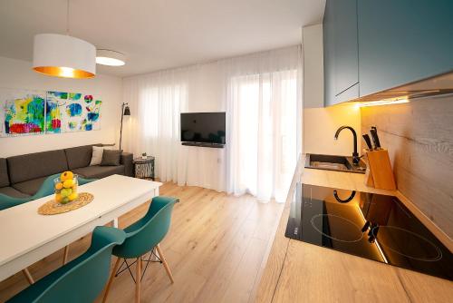 a kitchen and living room with a table and chairs at Apartment Noa Malinska in Vantačići