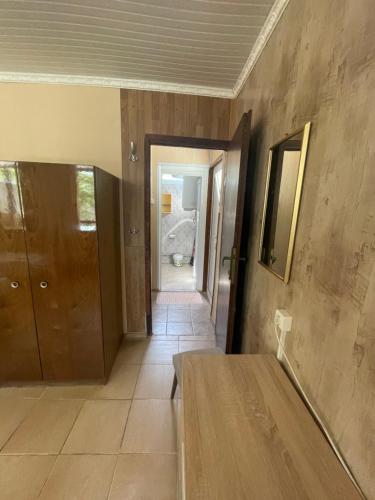 a hallway of a house with a table and a door at Bungalow Silitur in Ahtopol