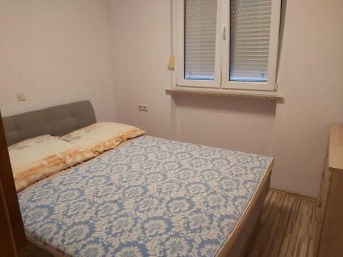 - une petite chambre avec un lit et une fenêtre dans l'établissement Valentina, à Vinišće
