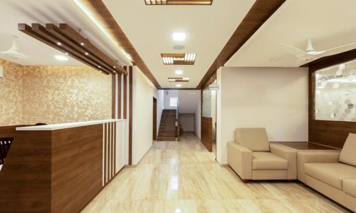 a hallway of a office with a couch and chairs at The Bee Hives , Nectar Nest in Coimbatore