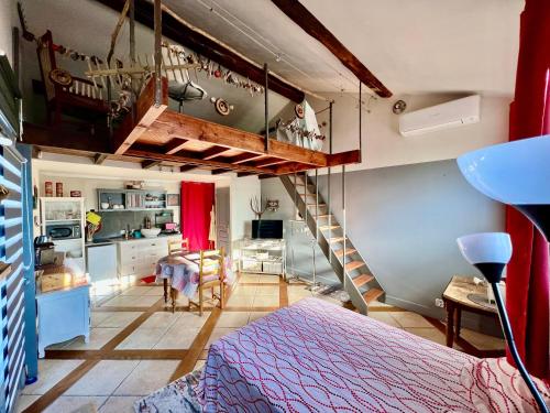 a bedroom with a loft bed and a staircase at Domaine Feuillet in Chanas