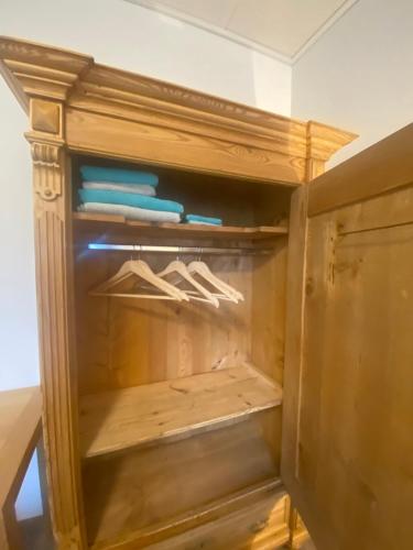 a wooden cabinet with its door open with at Colmdorf 14a Ferienhaus in Bayreuth