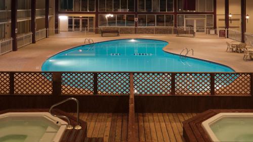 a large swimming pool in a building with two juzzles at Holiday Inn Spearfish-Convention Center by IHG in Spearfish