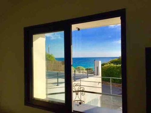 a view of the ocean from a window at Duplex vue mer plage de Saint-Clair in Le Lavandou