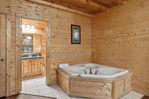 a jacuzzi tub in a log cabin bathroom at Amazing Grace #264 in Pigeon Forge