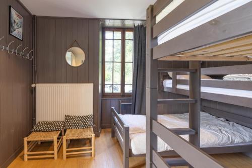 a room with bunk beds and a table and a chair at St Gervais Les Bains - Mont Blanc in Saint-Gervais-les-Bains