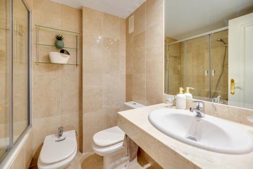 a bathroom with a sink and a toilet at Señorio de Aloha in Puerto Banus in Marbella