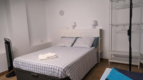 a bedroom with a bed with two books on it at Baywatch Penthouse in Altafulla