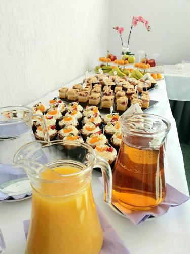 a table with a tray of food and two jars of honey at Hotel Gromada Poznań in Poznań