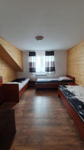 a large room with two beds and a window at Agro Karasiewo in Karasiewo