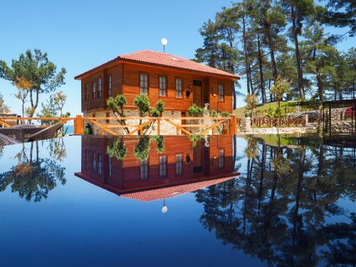 a house on the water with its reflection at Quiet Abana in Abana