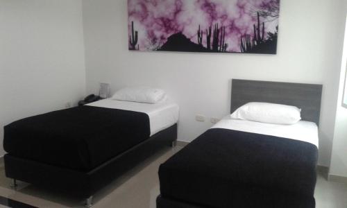 Postel nebo postele na pokoji v ubytování Hotel Onix T