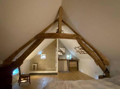 a attic room with a bed and a desk at Le Bouchat : Maisonnette au calme pour 2 +1 guest 