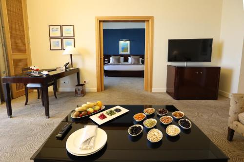 a hotel room with a tray of food on a table at Le Royal Hotel - Beirut in Beirut
