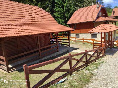 a large wooden building with a red roof at BRVNARA MILA in Zaovine