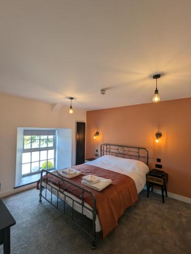 a bedroom with a bed and a window at The Wolfe Inn Wolfscastle in Haverfordwest