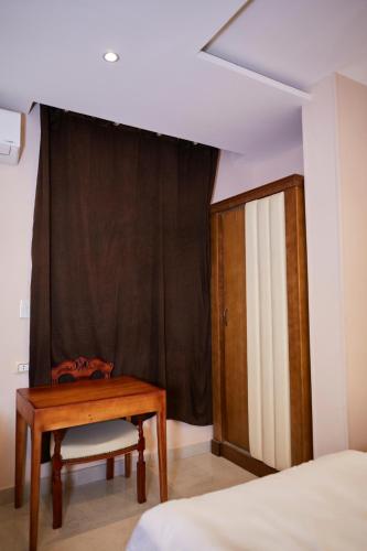 a bedroom with a table and a bed and a window at Grand Pyramid View Hotel in Cairo
