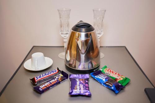 a table with a tea pot and two bags of candy at Grand Pyramid View Hotel in Cairo