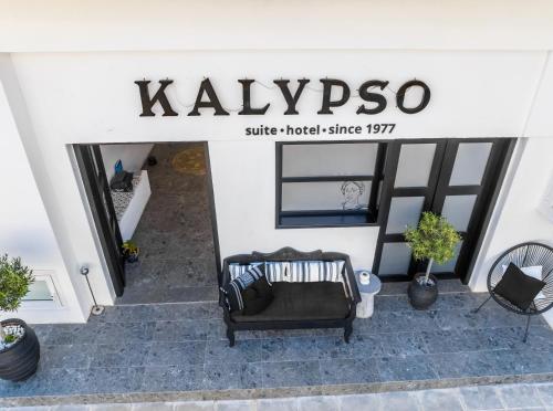 a store entrance with a chair in front of it at Kalypso Suites Hotel - Adults Only in Elounda
