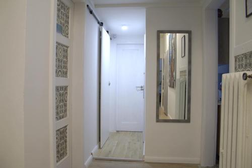 a hallway with a mirror and a white door at DOM WOLNOSTOJĄCY przy Krupówkach in Zakopane