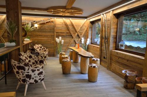 a room with wooden walls and chairs and a table at Hotel Cime D'Oro in Madonna di Campiglio