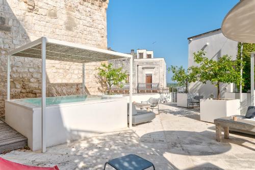 a swimming pool in a courtyard with a building at Arya Nobile Dimora in Carovigno