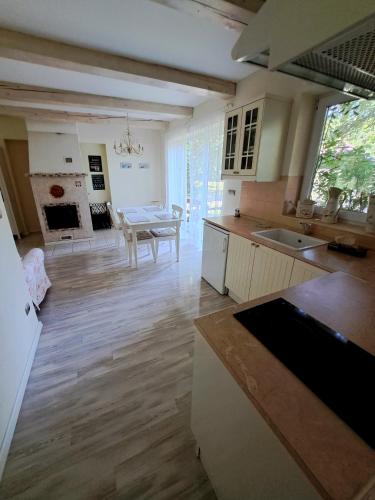 a kitchen and living room with a table and a dining room at Apartmánový dom Harmónia in Modra