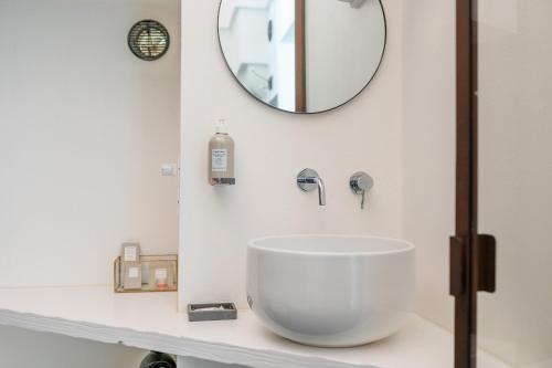 a bathroom with a large white sink and a mirror at Arya Nobile Dimora in Carovigno