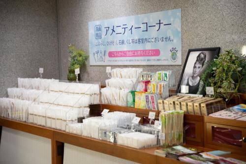 a store with a pile of toilet paper on a counter at Kagoshima Plaza Hotel Tenmonkan in Kagoshima