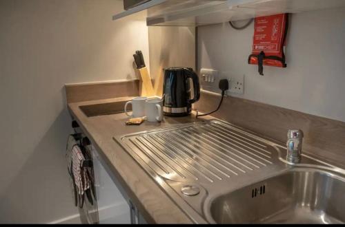 a kitchen counter with a sink and a coffee maker at Pass the Keys Centrally located Studio Apartment in Lincoln