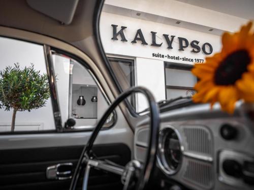 a sunflower sitting on the dashboard of a car at Kalypso Suites Hotel - Adults Only in Elounda