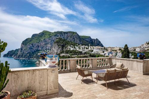 a balcony with a view of the ocean and mountains at Villa 4 Colonne, Capri in Capri