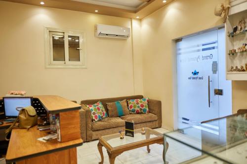 a living room with a couch and a table at Grand Pyramid View Hotel in Cairo