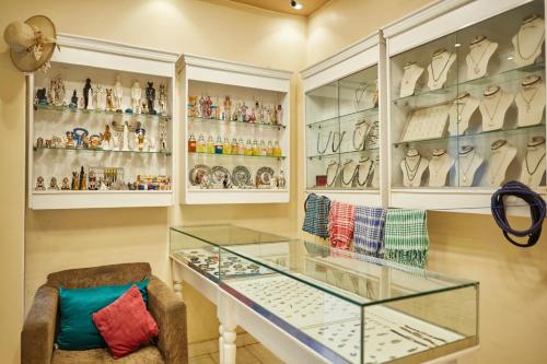 a room with a glass table and shelves of vases at Grand Pyramid View Hotel in Cairo