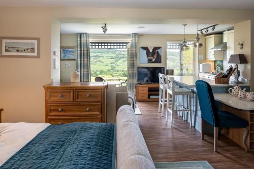 a bedroom with a bed and a kitchen with a table at Primrose Retreat in Whitby
