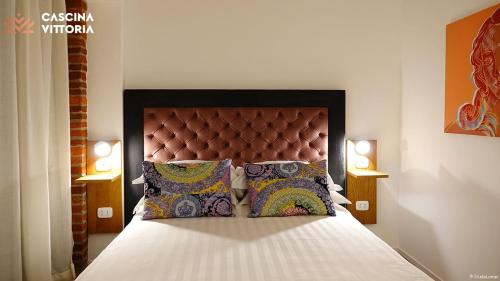 Posteľ alebo postele v izbe v ubytovaní Cascina Vittoria Restaurant Lab & Rooms