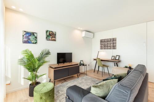 a living room with a couch and a tv at ALL4Braga - Minho's Guest in Braga