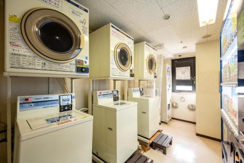 a laundry room with washers and dryers on display at Kagoshima Plaza Hotel Tenmonkan in Kagoshima