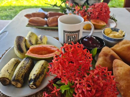 a plate of food with bananas and bread and a cup of coffee at The Ideal Bed & Breakfast in Nadi