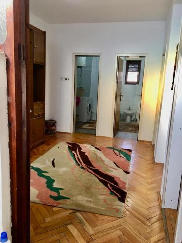 a living room with a rug on a wooden floor at Central Center Peja in Peje
