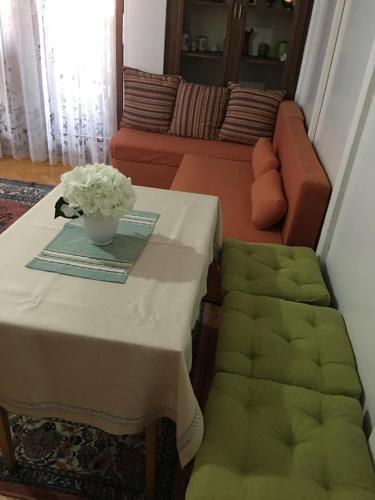 a living room with a table and a couch at Central Center Peja in Peje