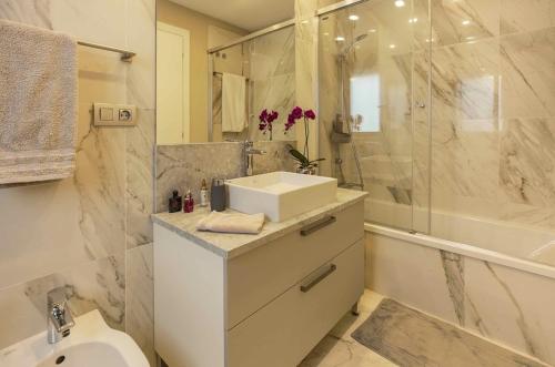 a white bathroom with a sink and a shower at Villa BLUE PORTOFINO Los Cristianos, POOL in Los Cristianos