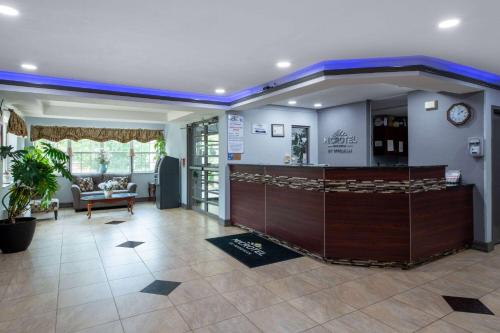 a lobby with a bar in the middle of a room at Microtel Inn by Wyndham Spartanburg Duncan in Duncan