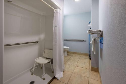 a small bathroom with a toilet and a shower at Microtel Inn by Wyndham Spartanburg Duncan in Duncan
