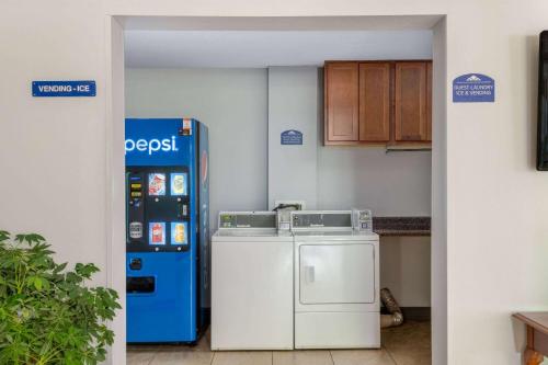 a kitchen with a washer and dryer next to a vending machine at Microtel Inn by Wyndham Spartanburg Duncan in Duncan