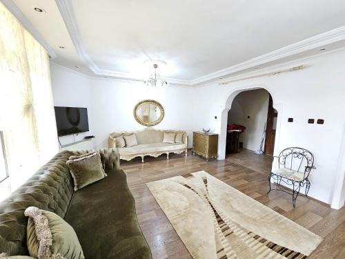 a living room with a couch and a table at Villa surrounded by nature in Kireçhane