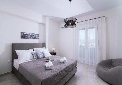 a bedroom with a bed with two towels on it at Athena Home South Crete in Kapparianá