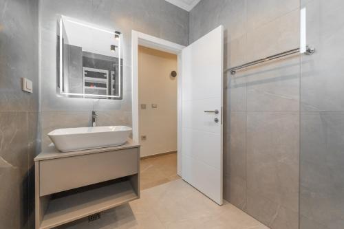 a bathroom with a sink and a shower at Apartments Oliv'e with jacuzzi in Novalja