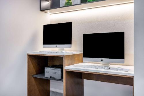 a desk with two monitors and a computer on it at La Quinta by Wyndham St. George in St. George