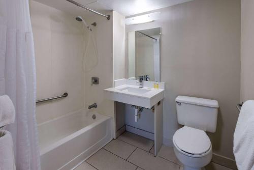 a bathroom with a sink and a toilet and a tub at Days Inn by Wyndham Winchester in Winchester
